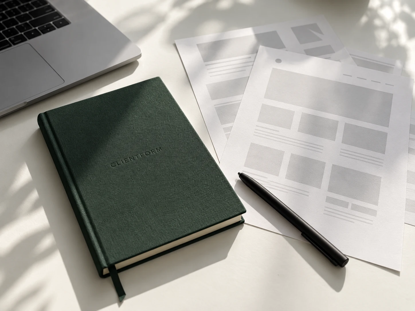 Clientform Studio planning desk with laptop, notebook and website layout sheets